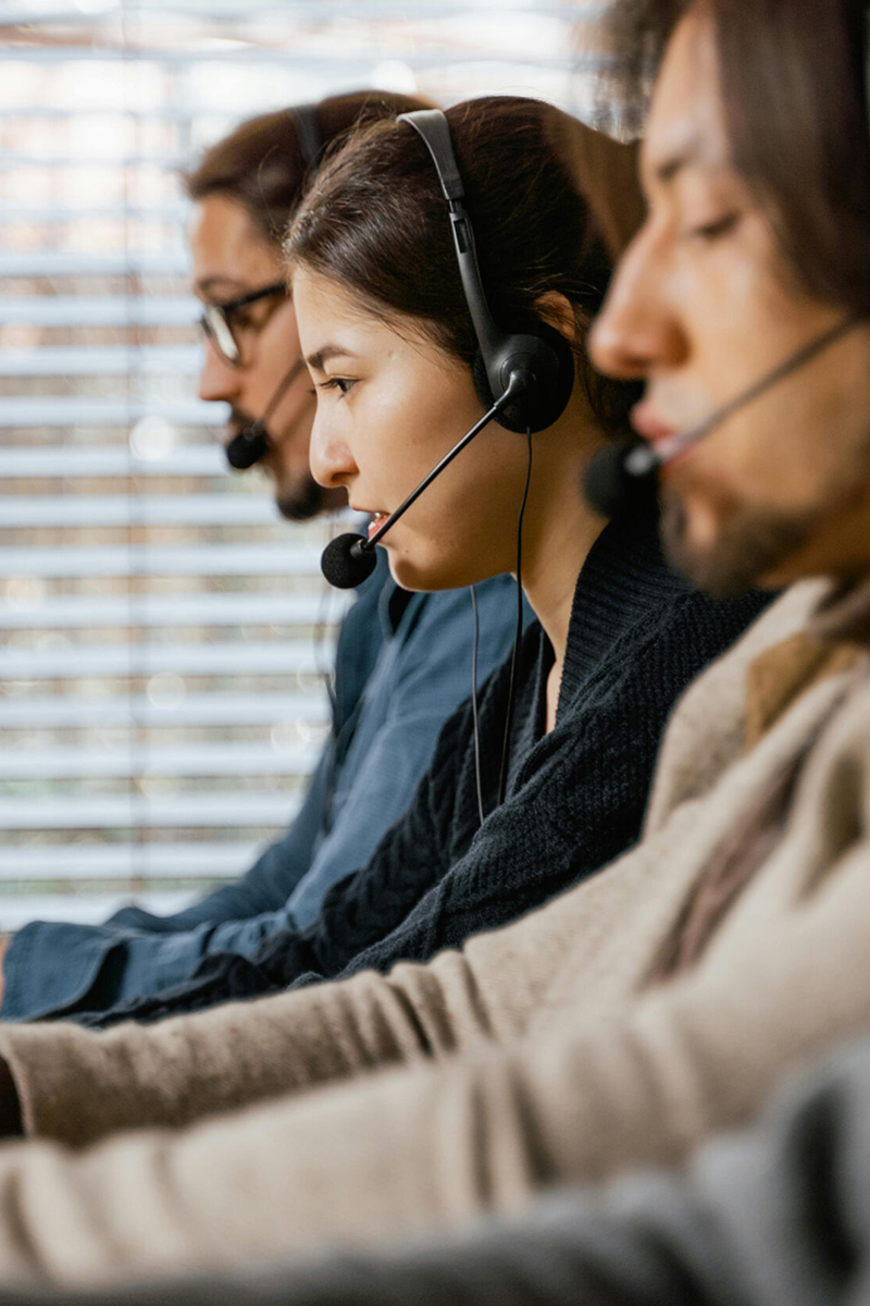 Call center agents with headsets — Helport.ai outsourced support teams for real-time performance monitoring and compliance